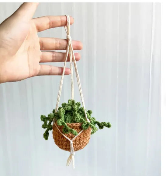 Knitted green and white car plant decoration with hanging rope