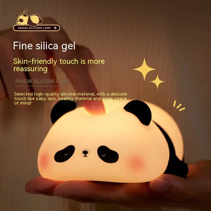 Cartoon panda-shaped silicone night light for kids on a bedside table.