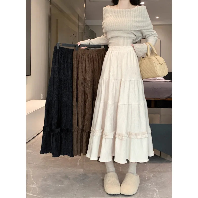 Korean-style solid colour corduroy A-line midi skirt with an elastic waistband.