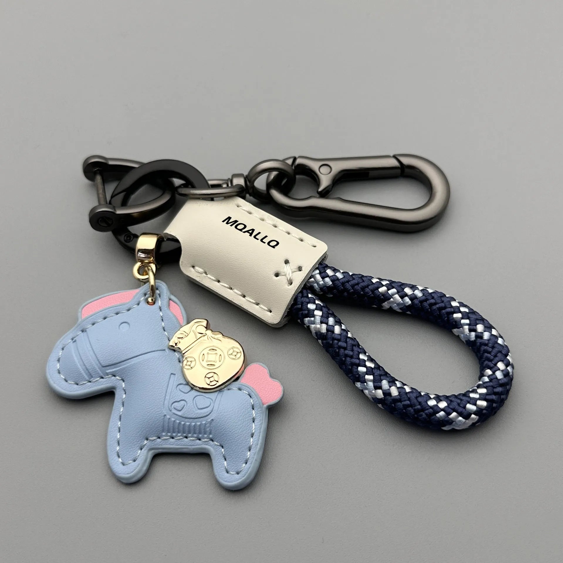 Handmade brown cowhide leather key ring with a gold pony belt buckle charm and a green flanelle rope loop.