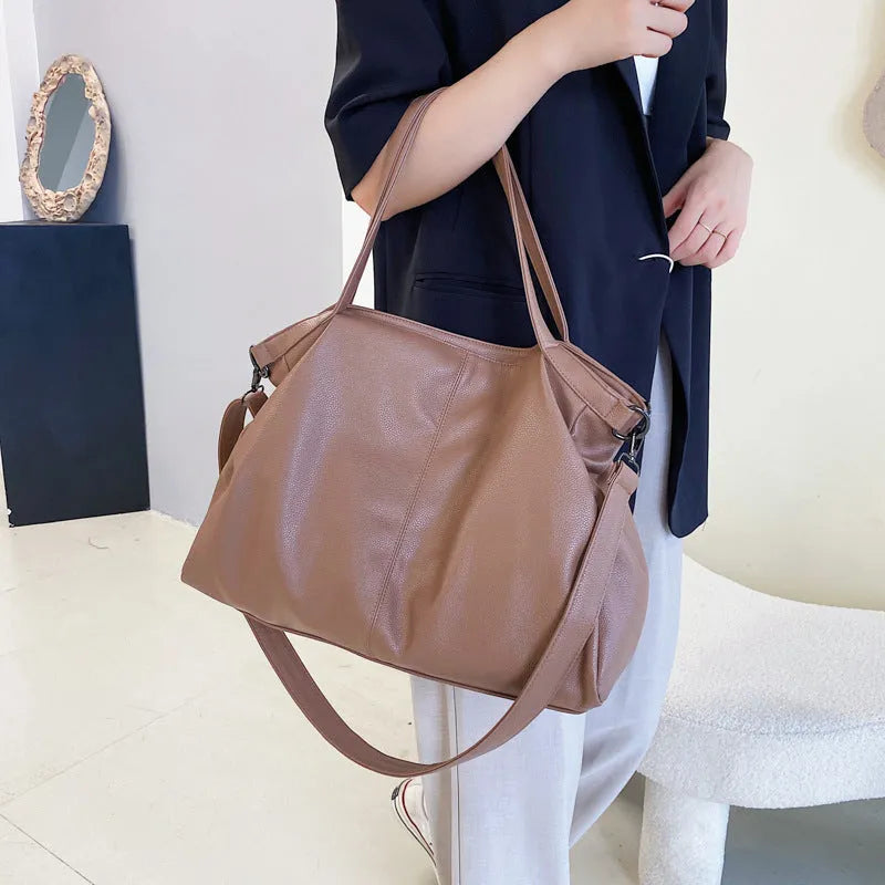 Large soft black PU leather messenger bag with adjustable shoulder strap and front zip.