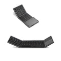 Folded and unfolded views of a black tri-fold portable Bluetooth keyboard on a table.