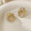 Gold-coloured copper wire flower basket earrings with small beads and inlaid pearls