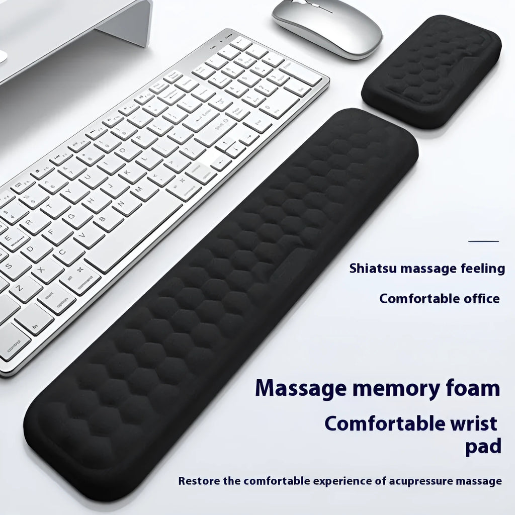 Black memory foam mouse wrist pad with silicone bottom on a wooden desk