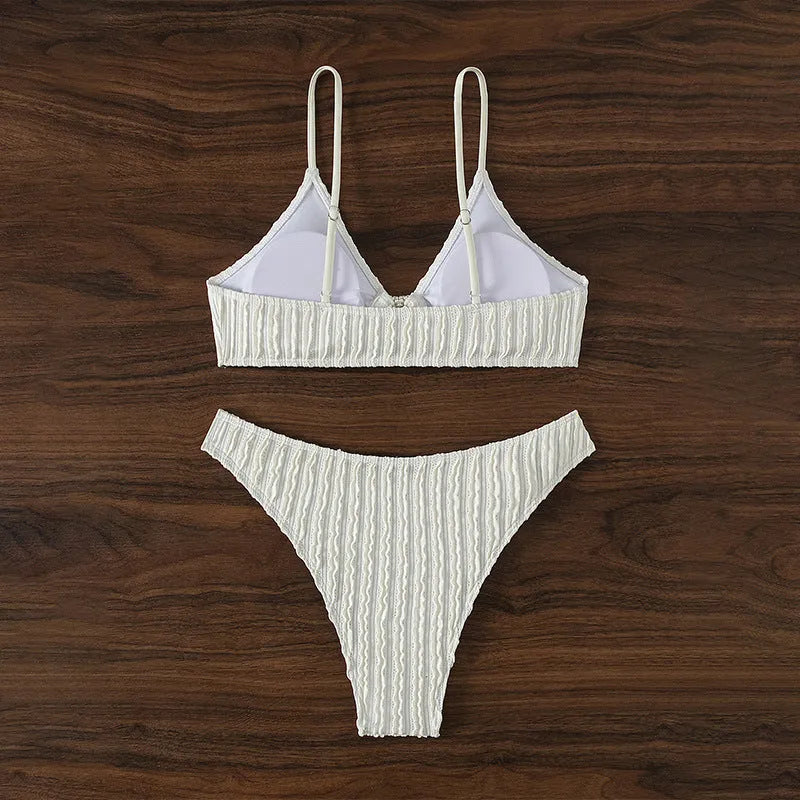 White women's V-neck swimsuit set with matching shorts on hanger