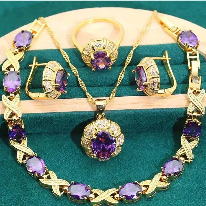 18k gold plated jewellery set with coloured cubic zirconia stones showing necklace, earrings, ring, and bracelet