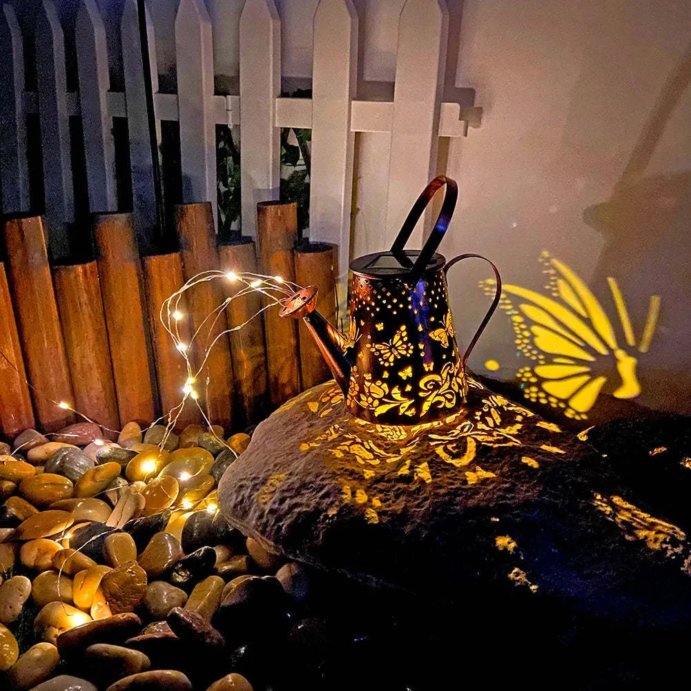 Solar-powered iron butterfly garden lamp with tapered silhouette and warm white LED light