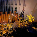Solar-powered iron butterfly garden lamp with tapered silhouette and warm white LED light