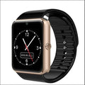 Black smart watch with a 1.54-inch touch screen and a black silicone strap on a wrist.