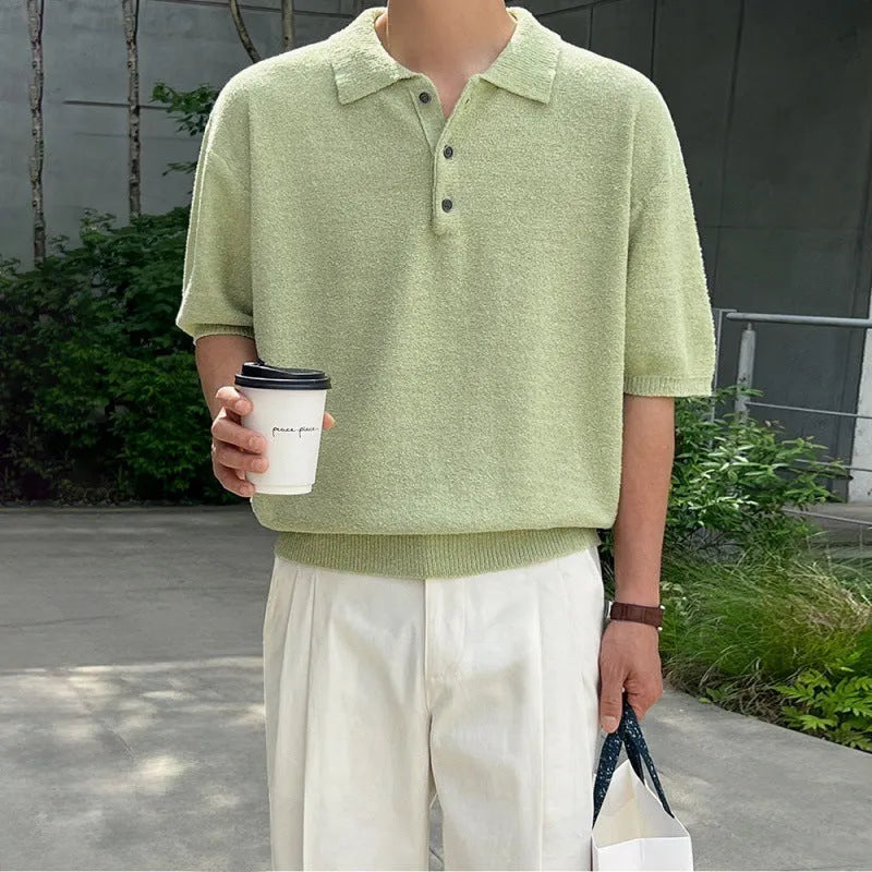 Man wearing a caramel-coloured loose-fit knitted polo shirt with short sleeves and an asymmetrical design detail.