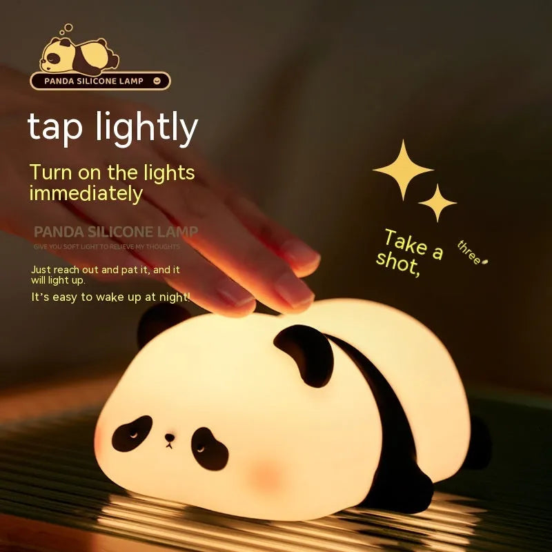 Cartoon panda-shaped silicone night light for kids on a bedside table.