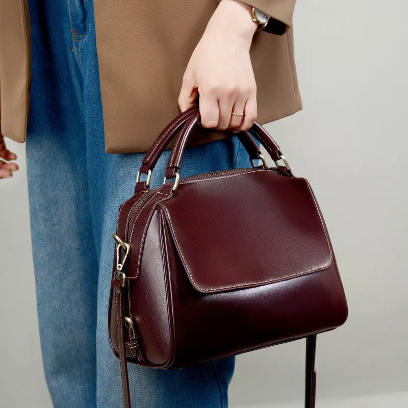 Women's genuine leather crossbody tote bag in apricot colour with double straps and outer slit pocket.