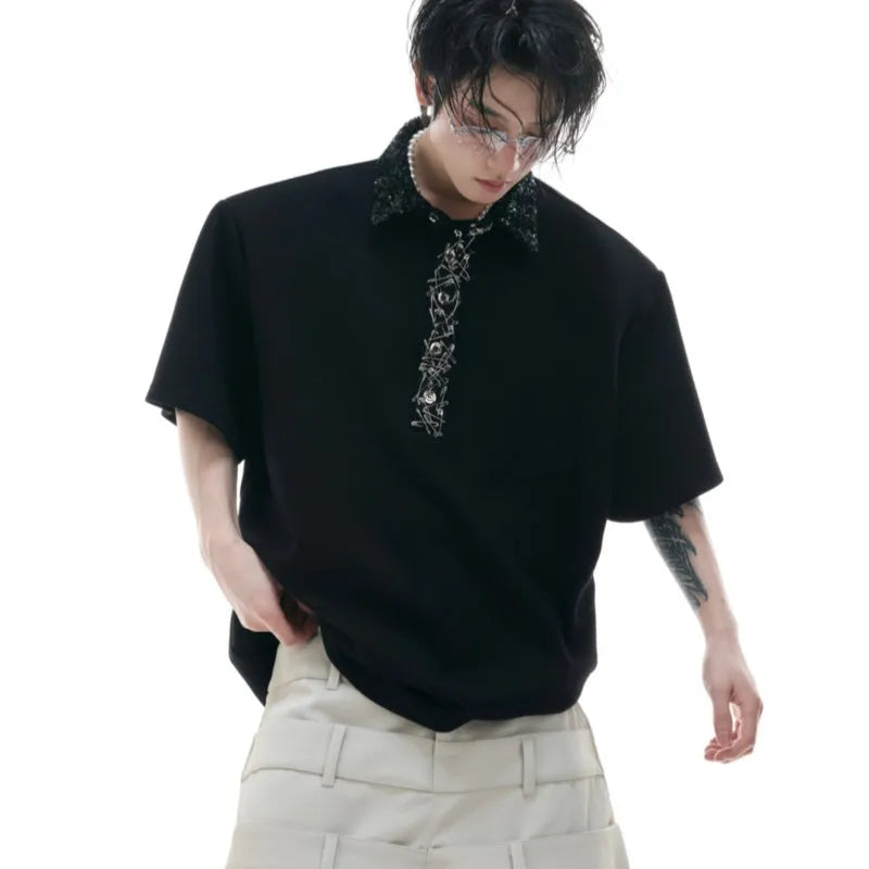 Man's black loose polo t-shirt with embroidery sequins detail and a square collar.