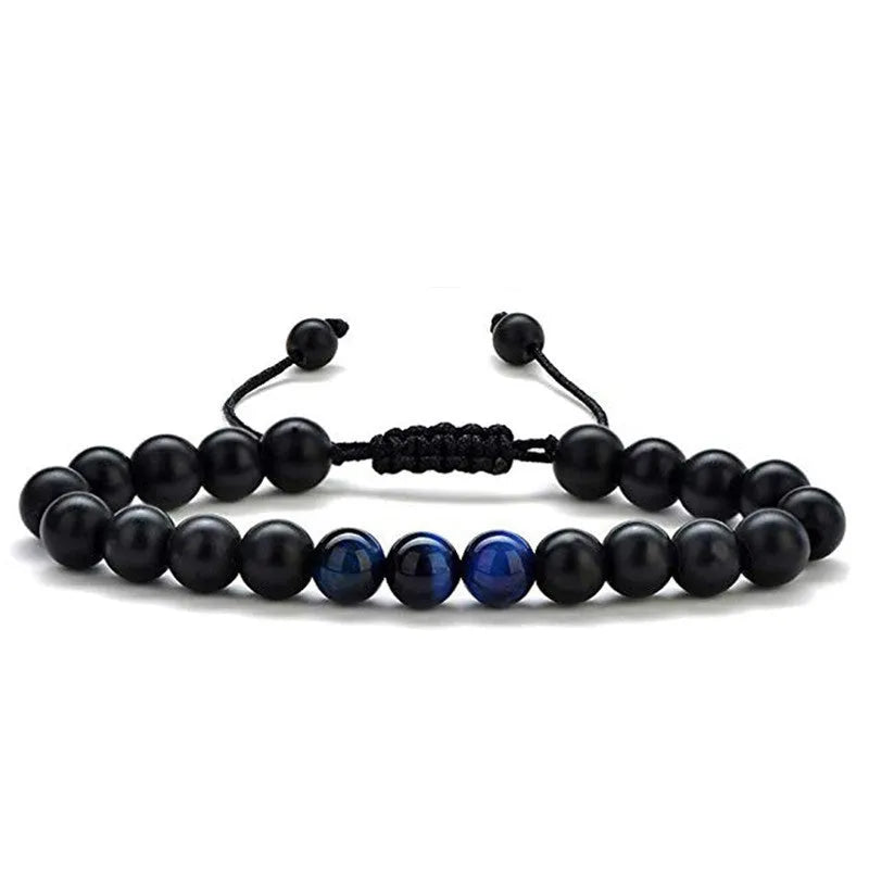 Matte black agate tiger eye bead couple bracelets with geometric design on a neutral background.
