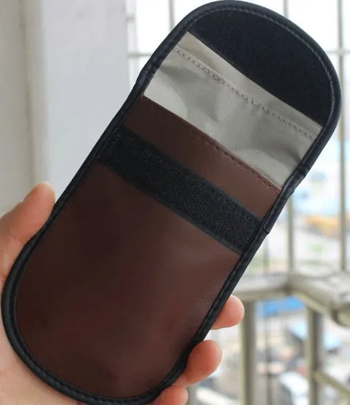 Black microfiber Faraday cage bag for blocking car key and phone signals, measuring 13.5 by 9.5 cm.