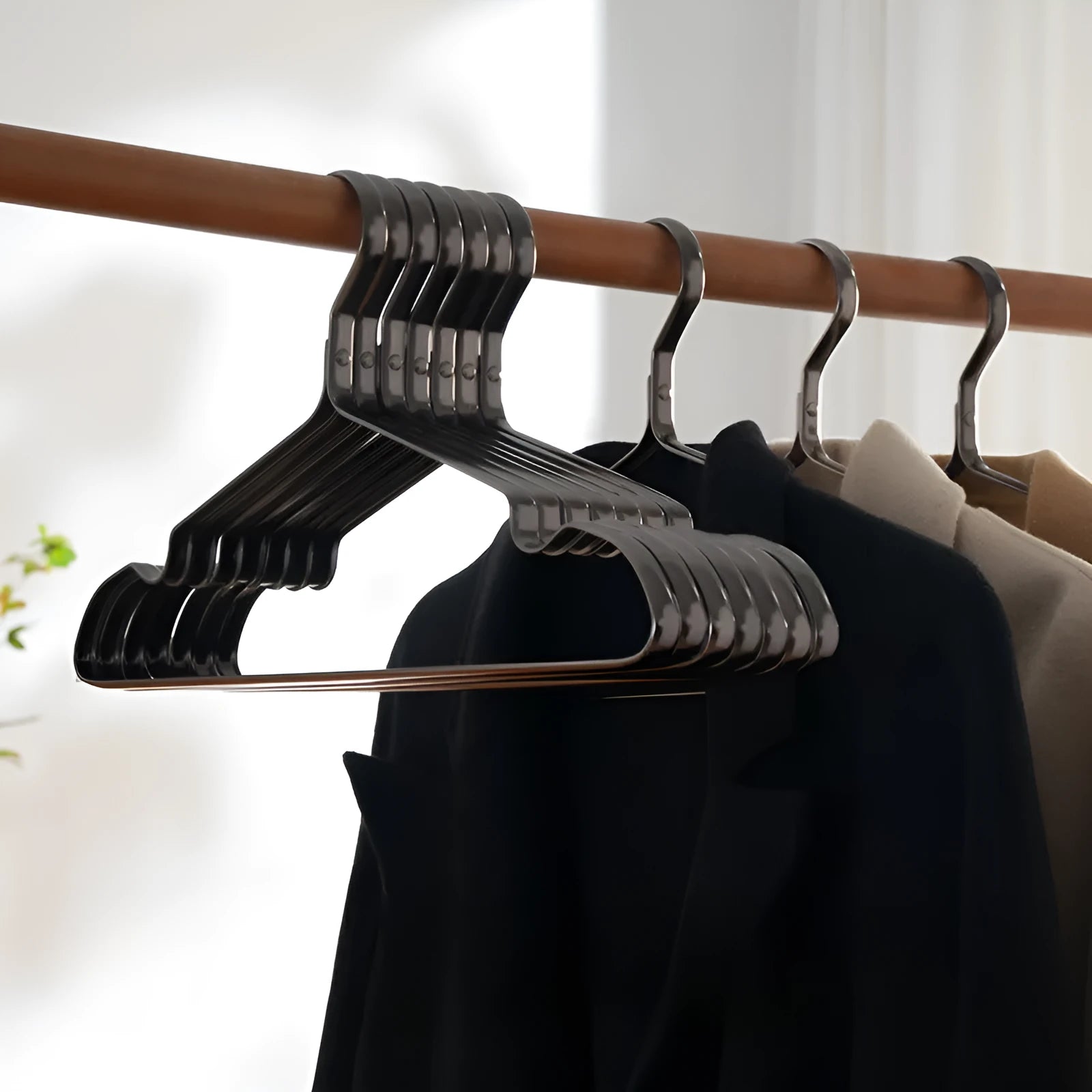 A single elegant black non-slip clothes hanger on a white background.