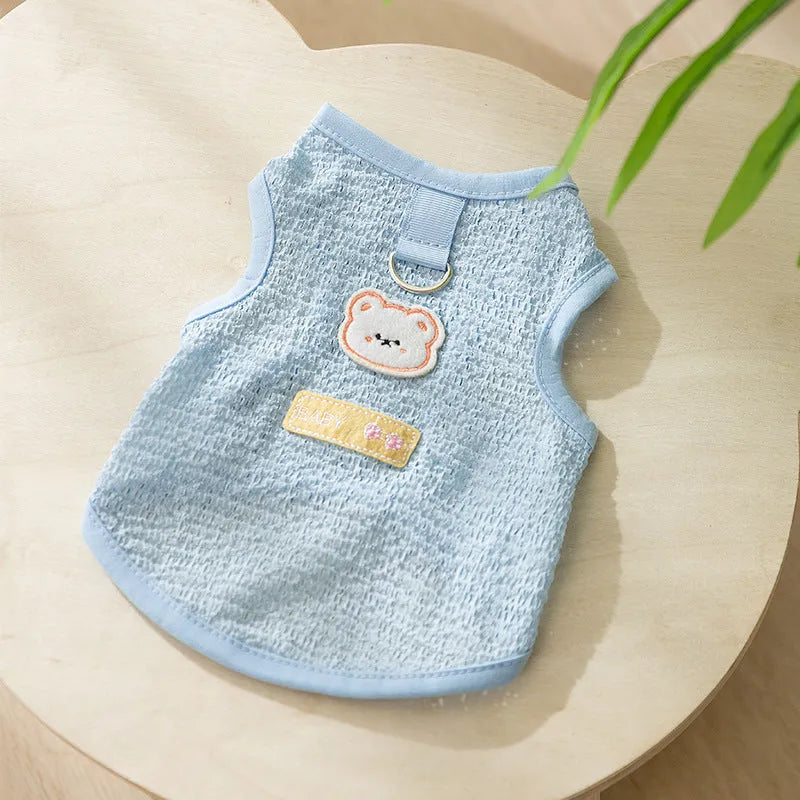 Green knitted cat clothing with bear patch design showing hollowed-out breathable fabric construction