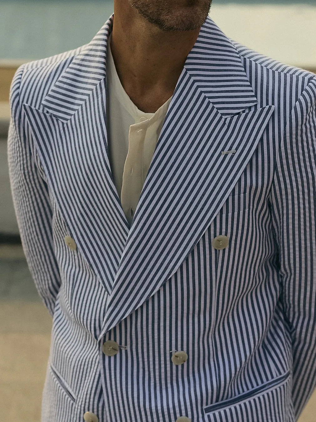 Blue and white striped men's suit set with blazer and trousers on a mannequin