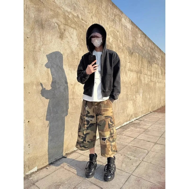 Men's straight-leg cropped jeans in camouflage pattern with patchwork detailing and distressed rips
