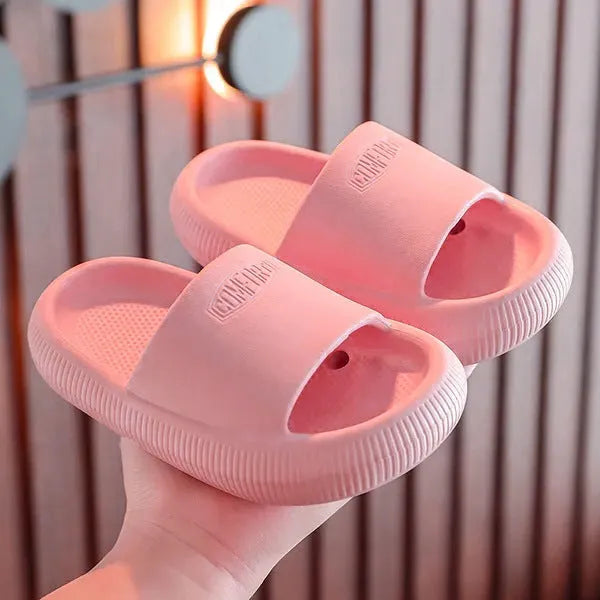 Colourful children's EVA slippers with a thick, textured non-slip sole in various sizes.