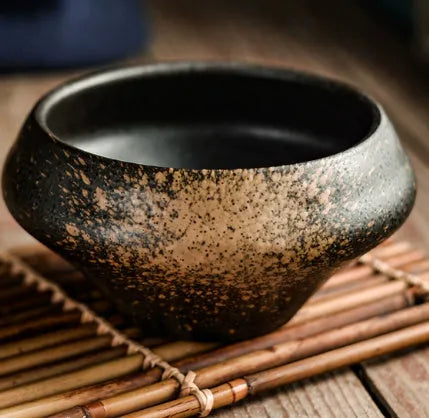 Ceramic tall Japanese soup noodle bowl in a retro glaze colour on a wooden table.