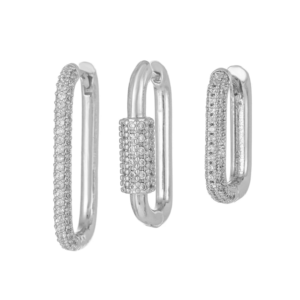 Geometric ear clips set with micro inlaid zircon detailing on copper, showing ellipse and quadrilateral shapes in gold and white finishes