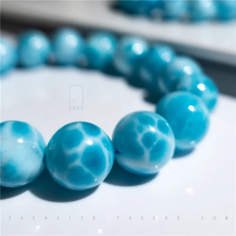 Blue Maillard style bodhi bracelet with natural crystal, sea-pattern stone, and a pearl bead.