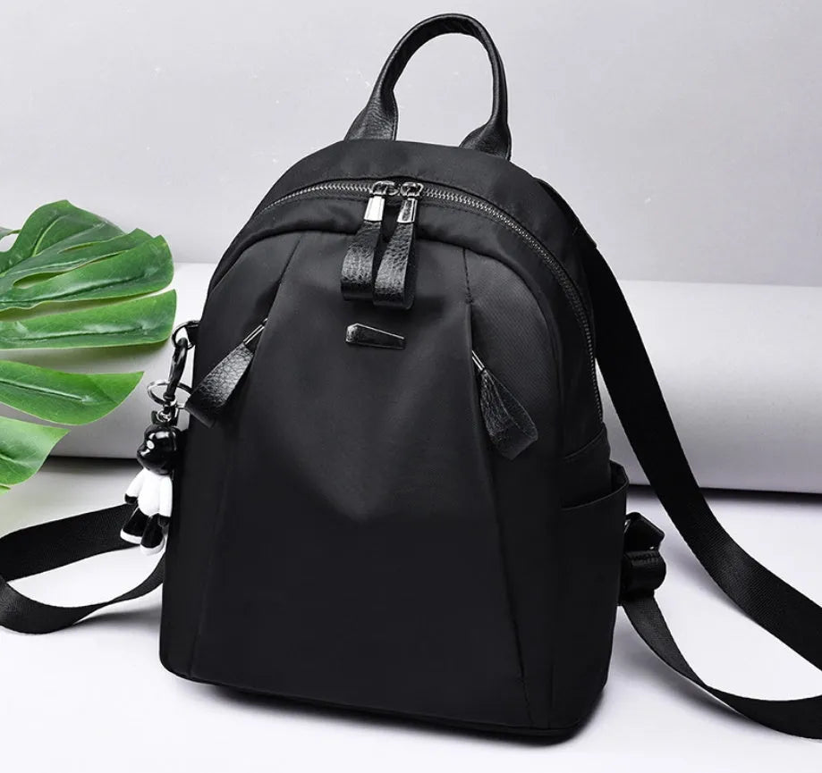 Medium capacity Oxford cloth rucksack in wine red with double straps and organised internal compartments