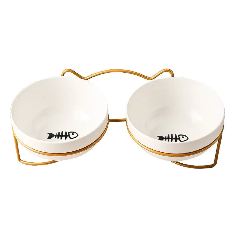 White ceramic cat food bowl with cat paw print design on black iron frame stand