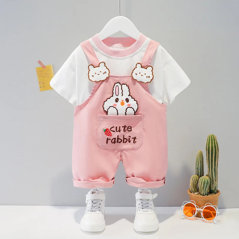 Baby wearing yellow cotton short-sleeved overalls with a cartoon print and openable straps.