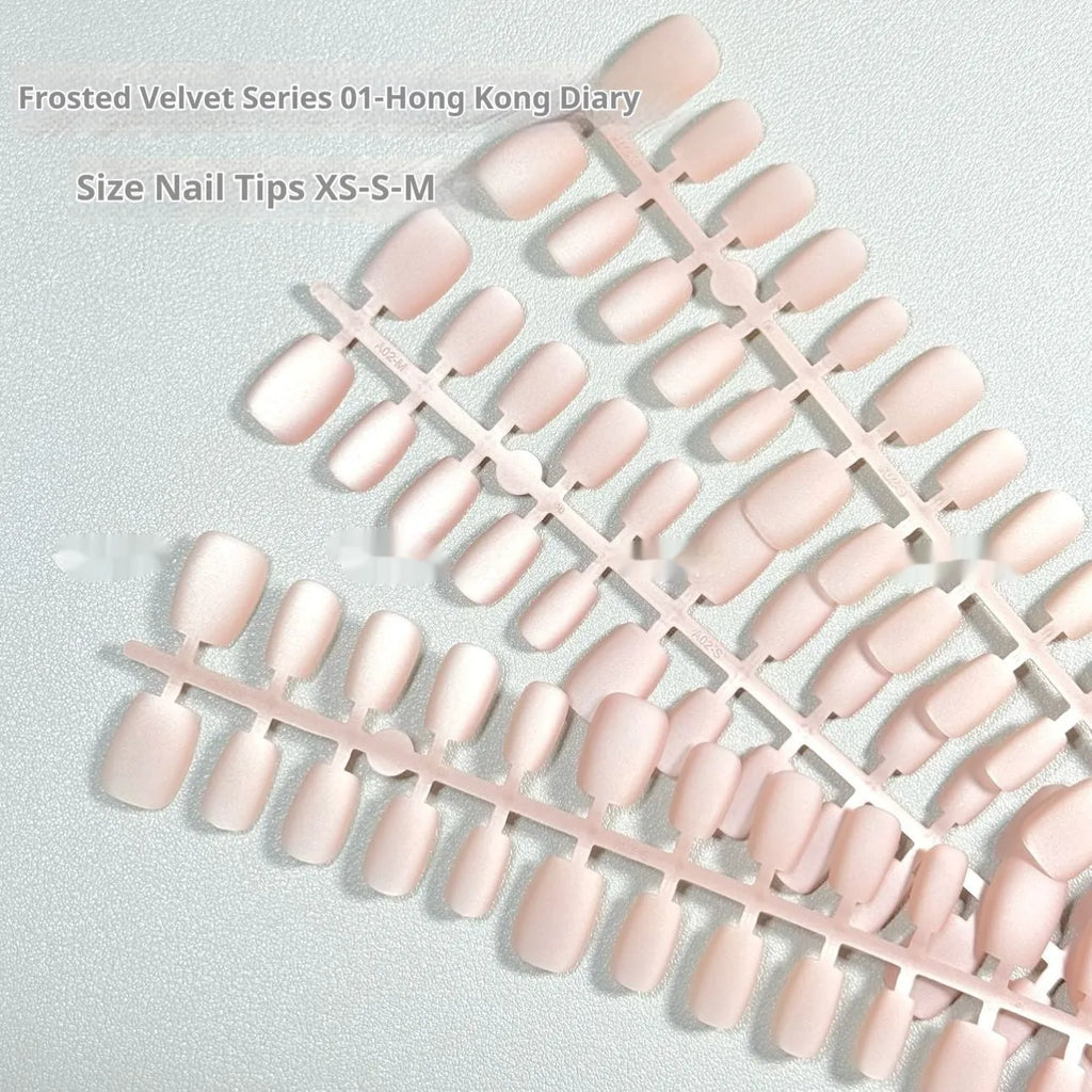 Set of frosted velvet false nails with Cat's Eye reflection in short ladder shapes on a display stand.