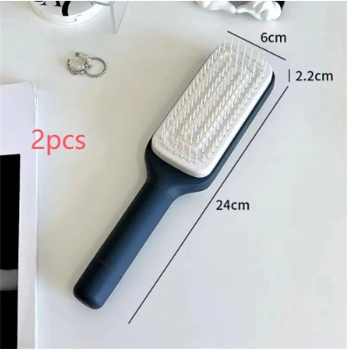 Roland purple self-cleaning hair brush with rotating handle and anti-static massage bristles.