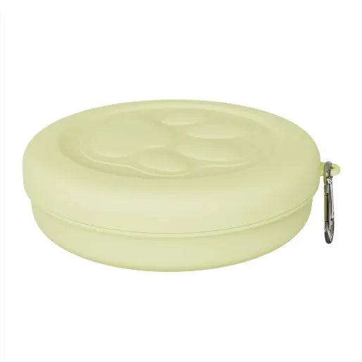 Portable dog feeding bowl with integrated snack box and water compartment, shown in green and pink colour options.