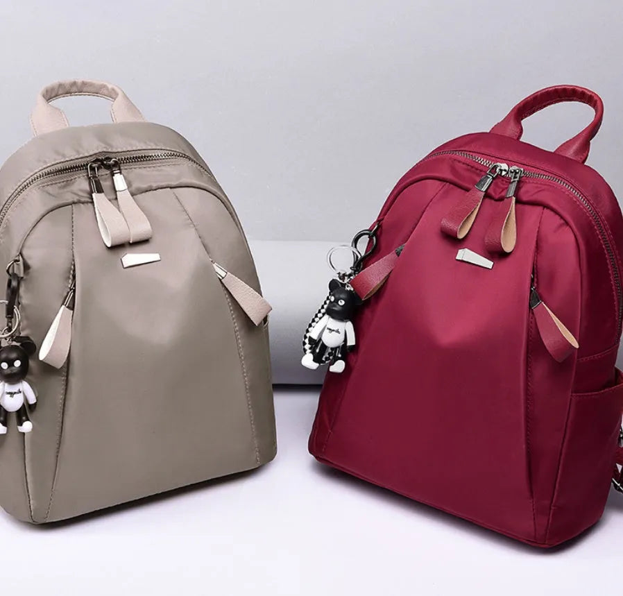 Medium capacity Oxford cloth rucksack in wine red with double straps and organised internal compartments