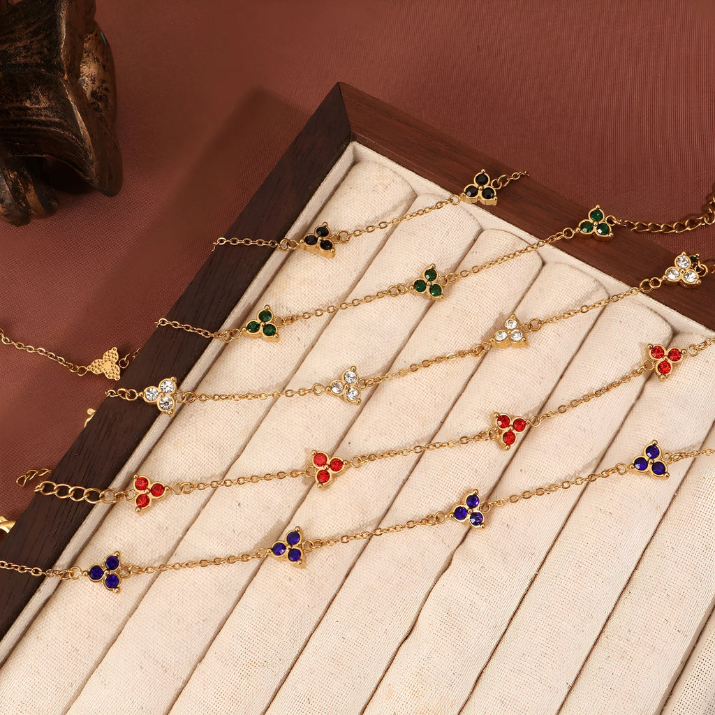 Women's geometric stainless steel bracelet with triple diamond design and coloured stone in gold or steel tone.