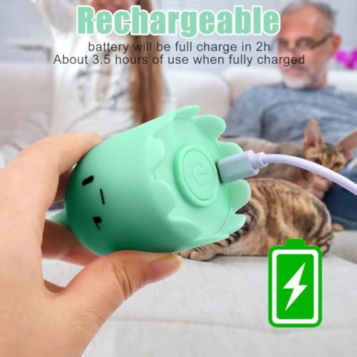 Green automatic electronic cat wand toy with swinging silicone tails on a table.