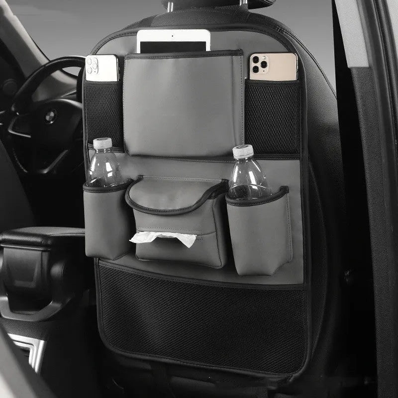 A leather car seat back storage bag hanging behind a vehicle seat.