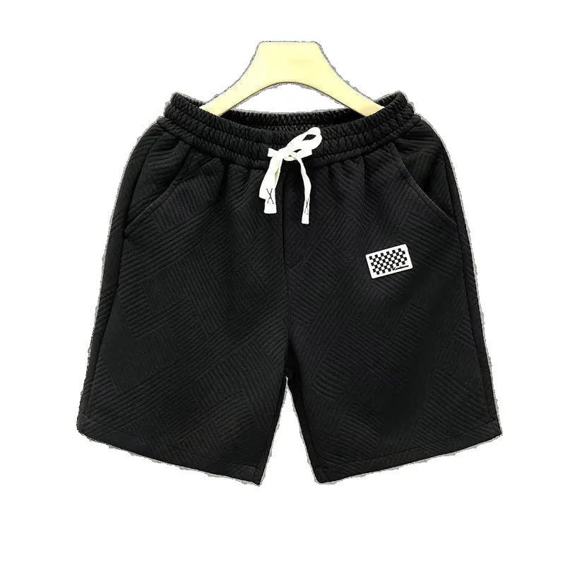 Men's solid colour polyester sports shorts on a hanger, showing elastic waistband and casual cut.