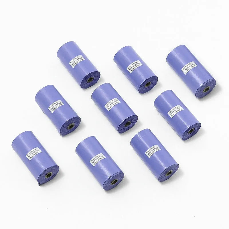 Rolls of green, black, blue, purple, and orange EPI degradable pet poo bags with a plastic dispenser.