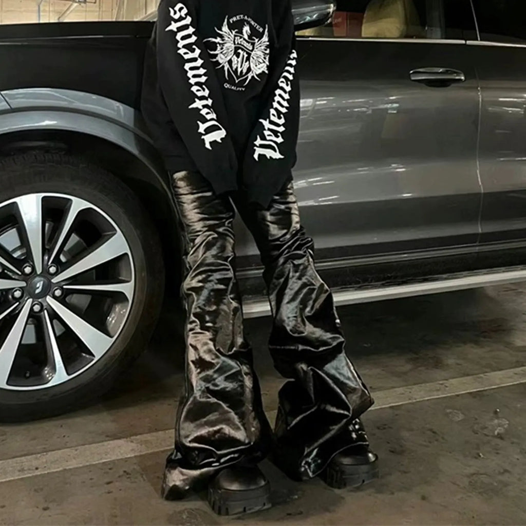 Black coated patent leather straight-leg skinny jeans on a hanger