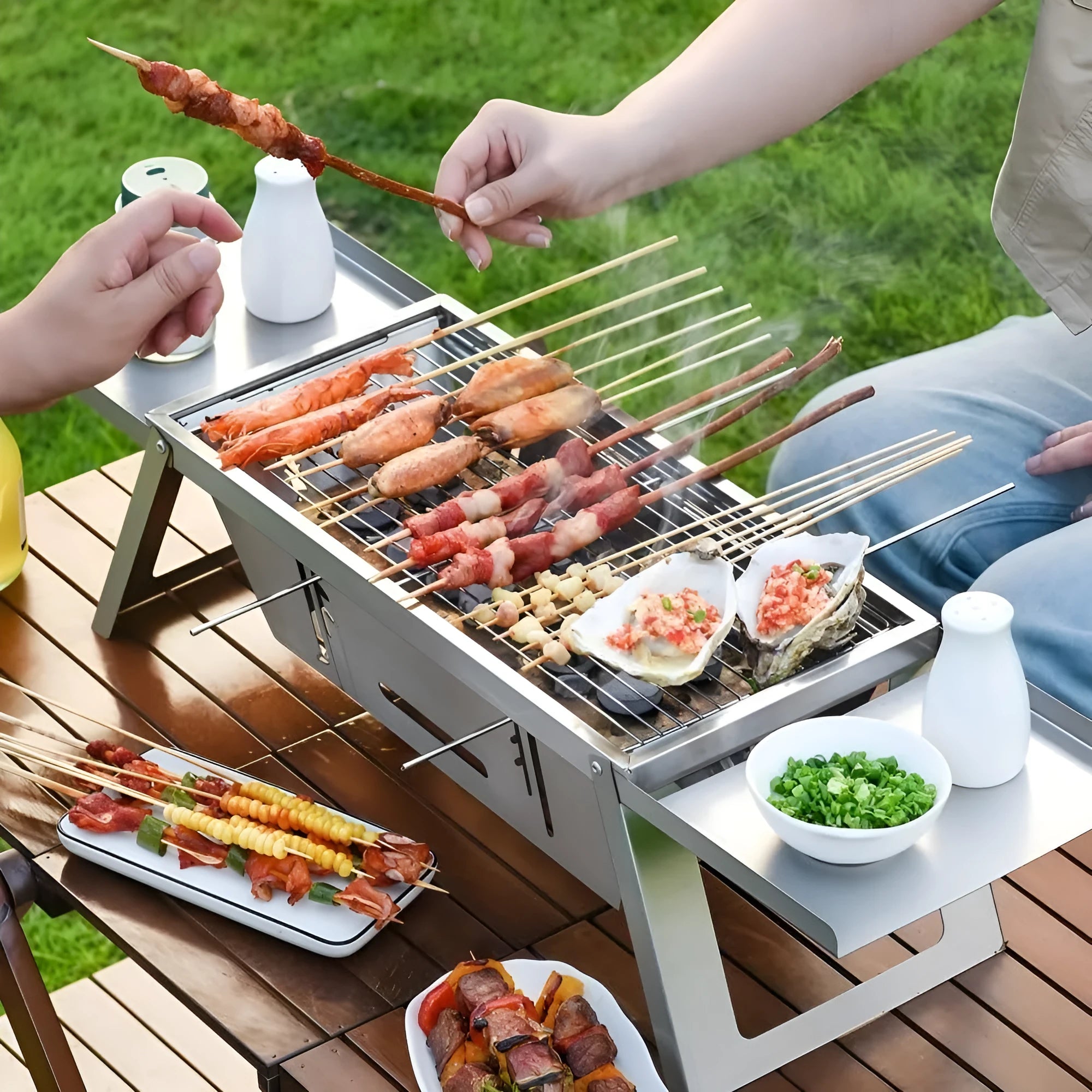 Small metal foldable portable charcoal grill for outdoor camping and picnics