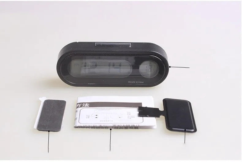 Black car electronic clock thermometer with digital LED display showing time and temperature