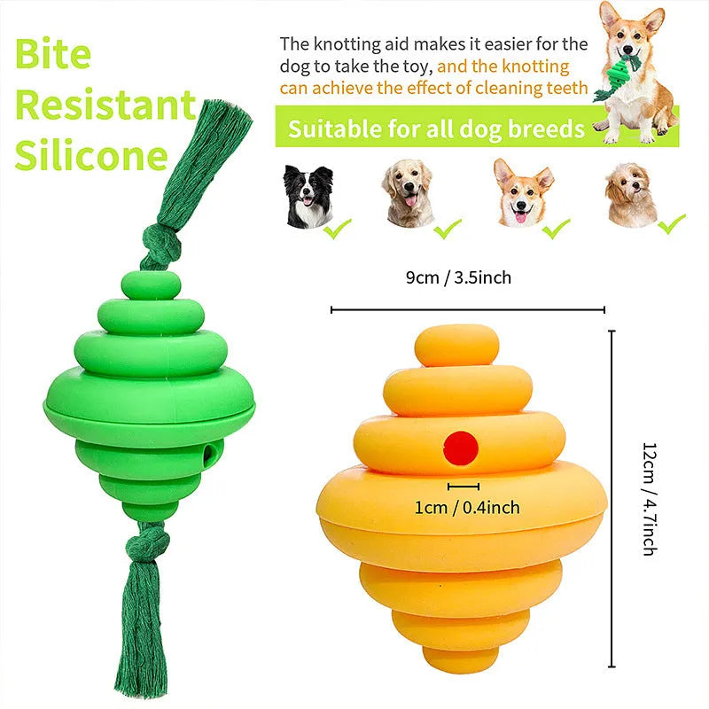 Green and yellow silicone dog ball with attached knot rope toy on grass.