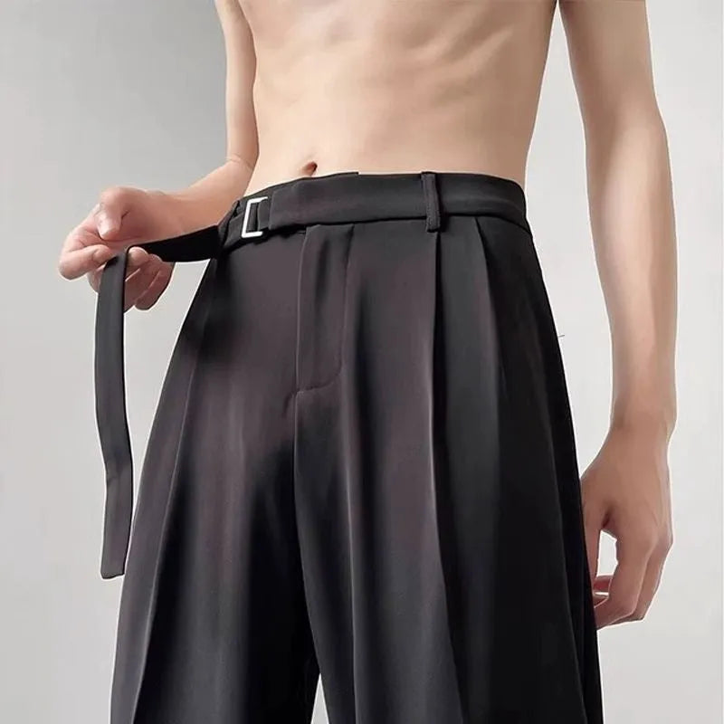Black wide leg straight trousers with a loose fit on a hanger.
