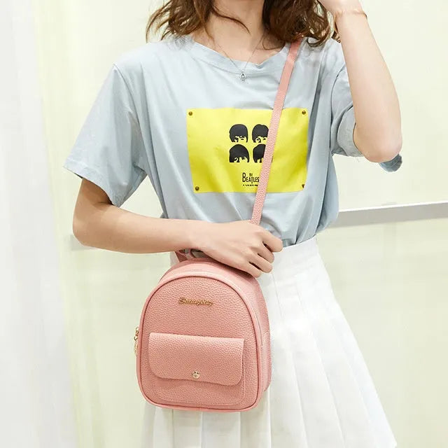 Women's small PU backpack shoulder bag in black, blue, grey, pink, or red with zipper closure