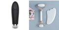 Natural white jade double-headed facial roller and matching scraping board set on a flat surface.