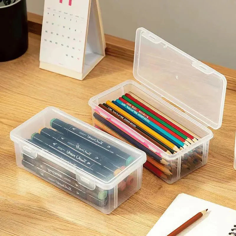 Transparent plastic stationery storage box containing pencils and coloured art supplies