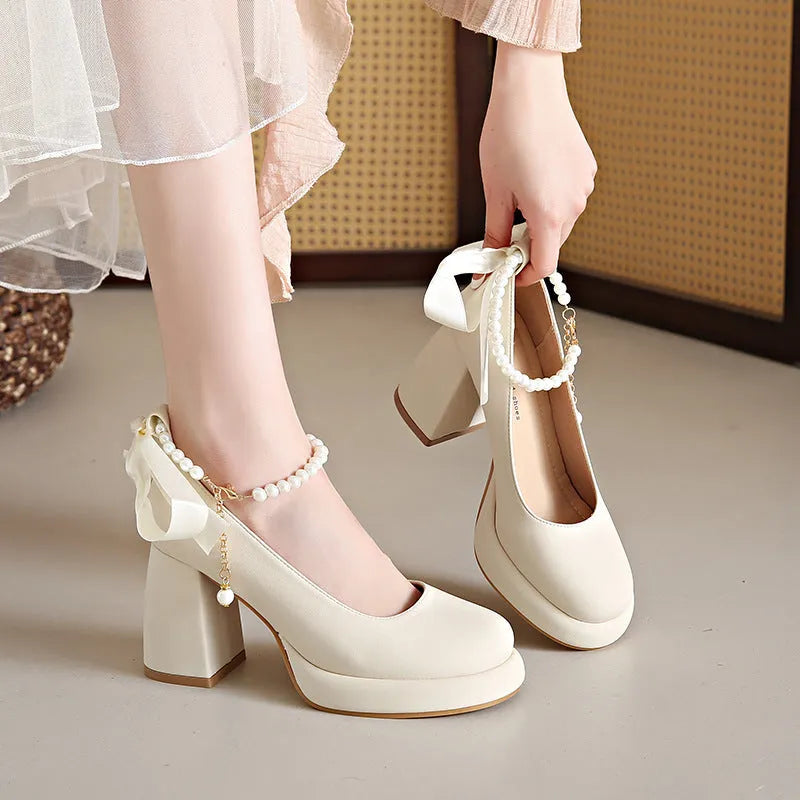 Women's beige Mary Jane shoes with a chunky heel and silver ankle-strap buckle on a round toe PU upper.