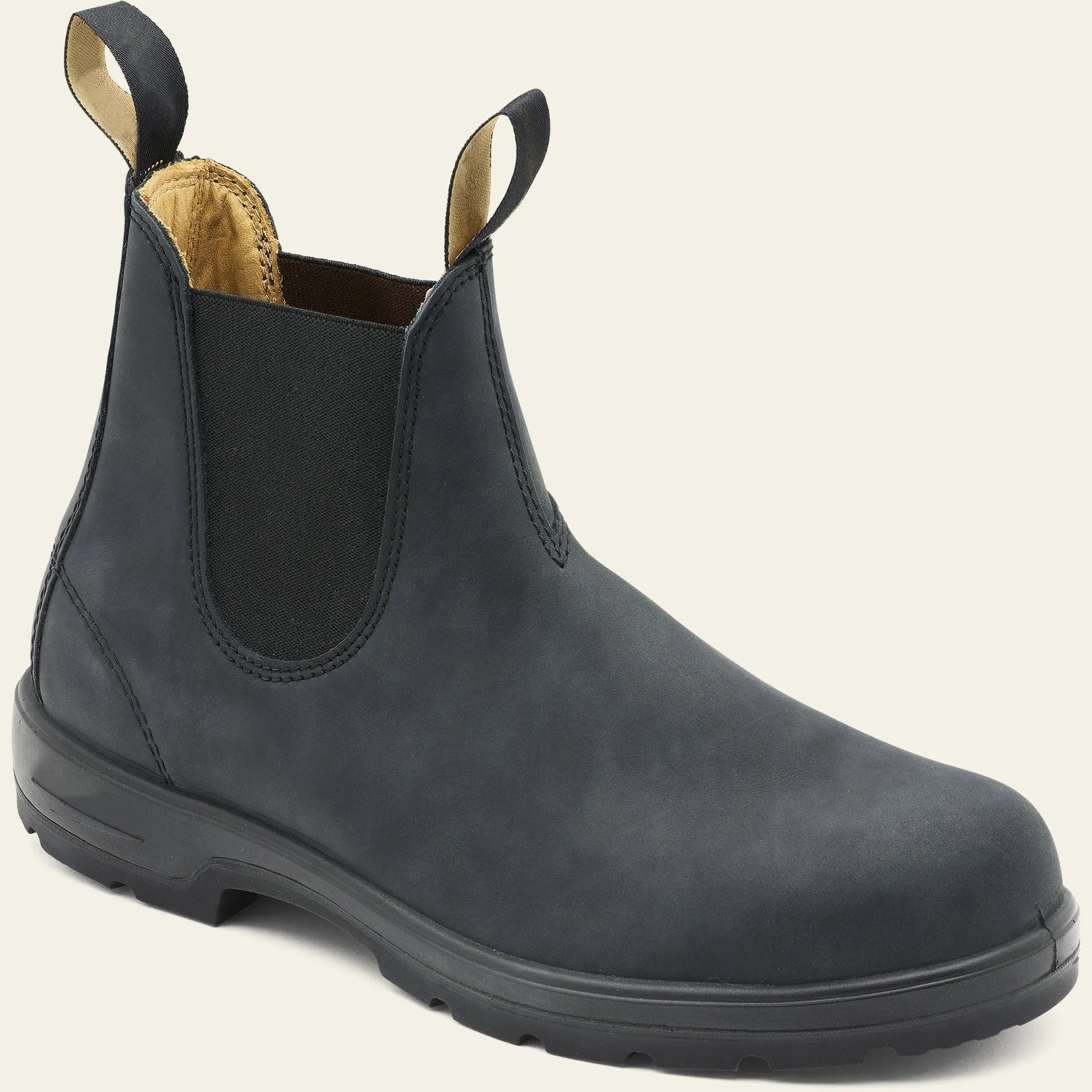 Vintage brown frosted finish Chelsea boots with car suture detailing on a wooden floor.