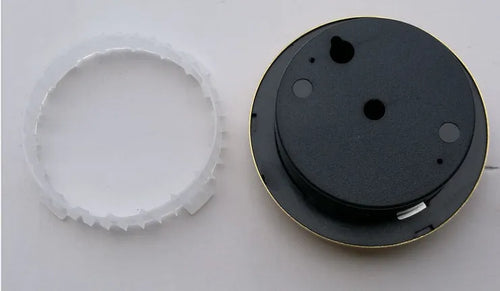 Analog thermometer and hygrometer with silver aluminum outer ring and dial on a white background